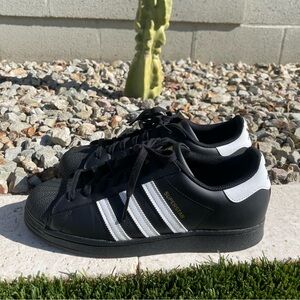 Adidas black men’s size 10 1/2 Superstar shoes.